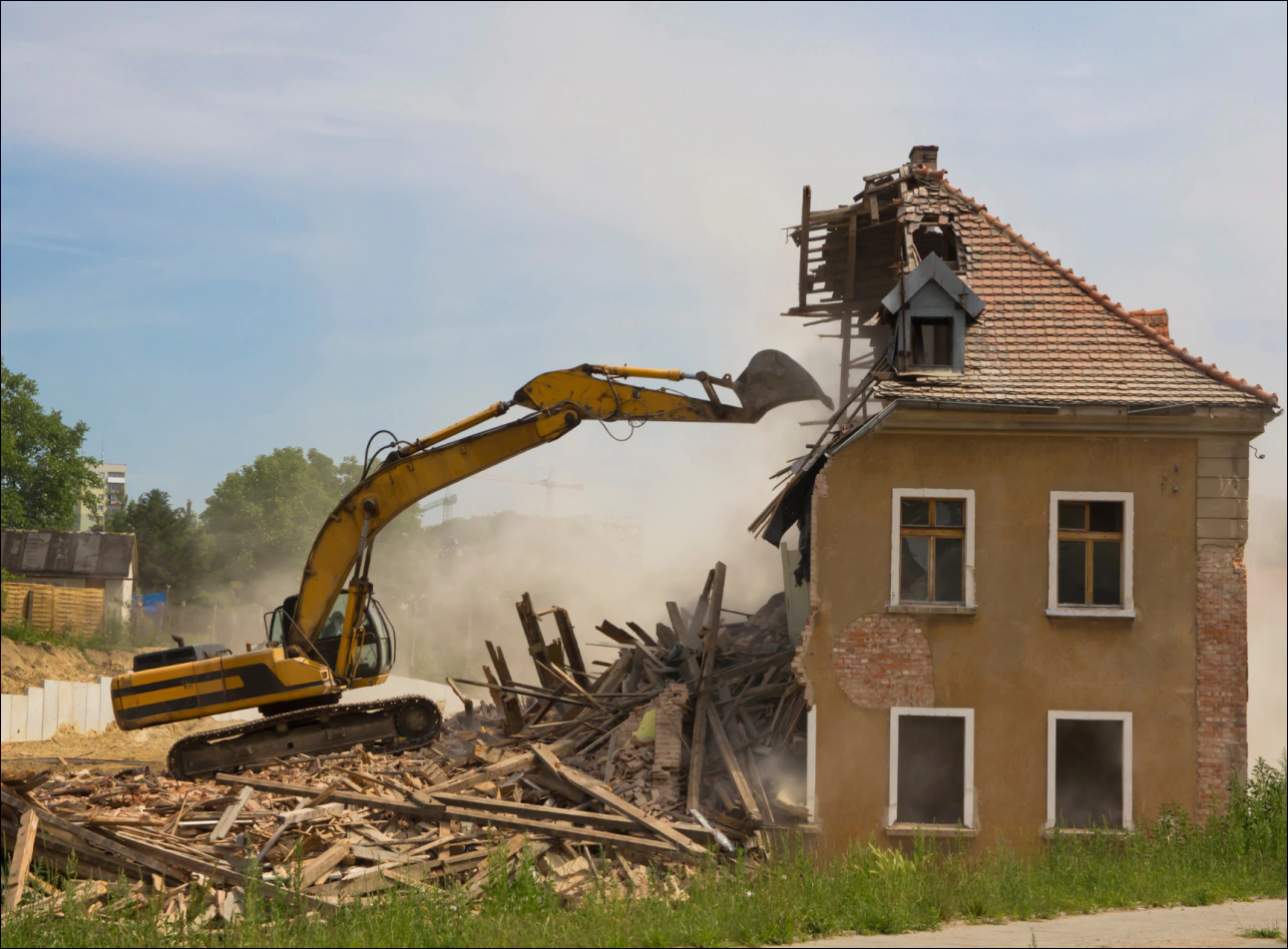 a machine demolishing a house